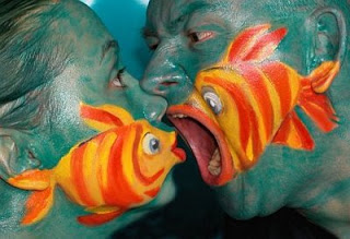 People with fish painted on their faces looking fishy.